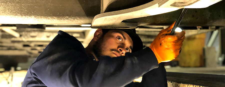 Mechanic inspecting bus